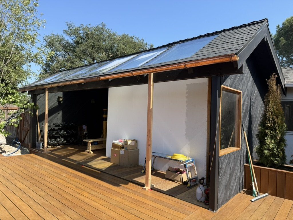 Copper gutter installed overhead with sliding glass doors under construction