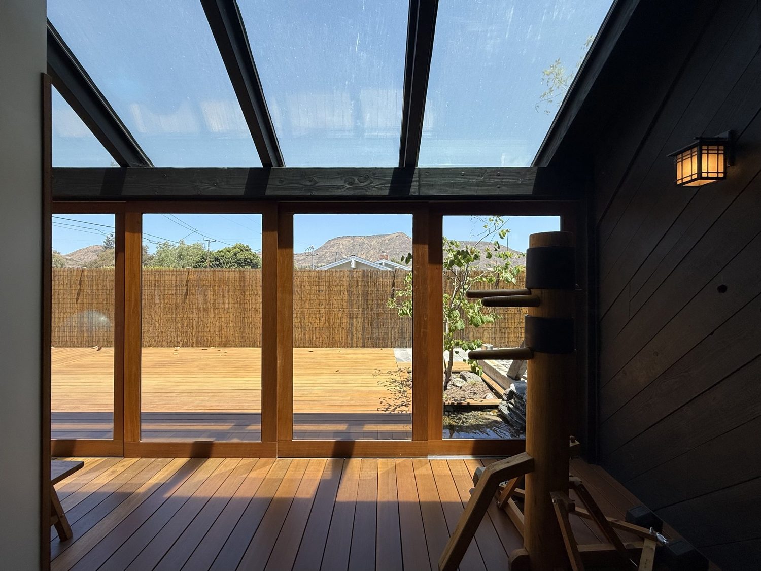 Interior dojo space at golden hour with striking station, sink, and mountain view