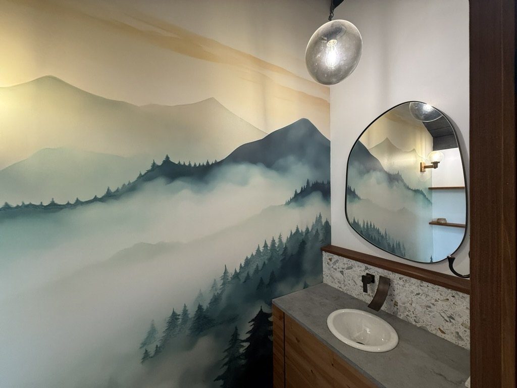 Powder room with hand-painted mountain mural