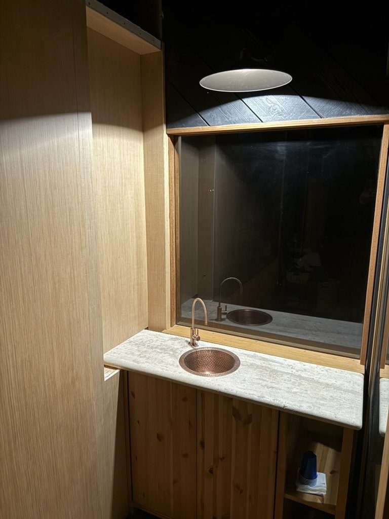 Light wood paneling installation along the hydration hallway